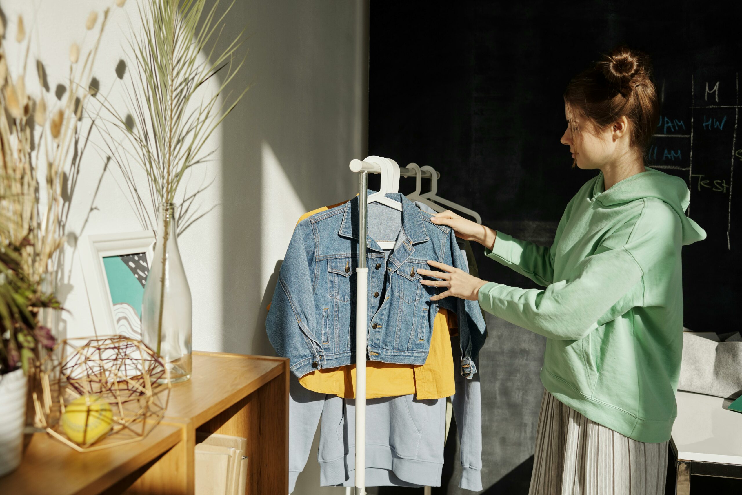 woman choosing what to wear from her capsule wardrobe