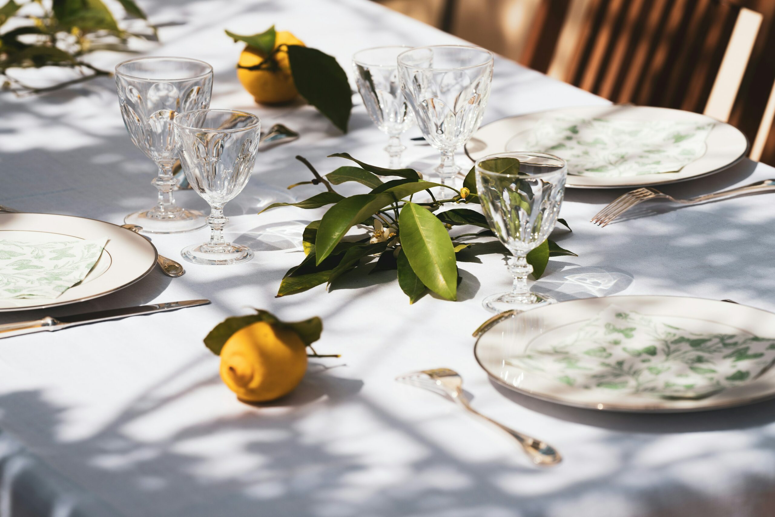 Simple tablescape set up with white tablecloth and delicate tableware