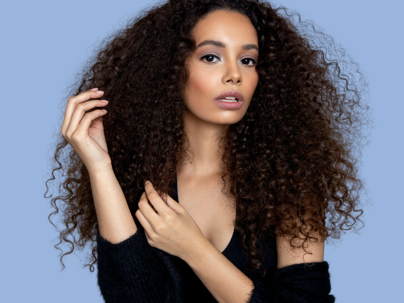 african american woman touching her beautiful curly hair. Hair type, porosity, density and texture